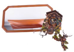 A modern cuckoo clock together with a modern wall mirror with half boat model display (2).