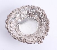 A heart-shaped dish with pierced embossed decoration, three ball feet, Birmingham, makers M.B, 8.9cm