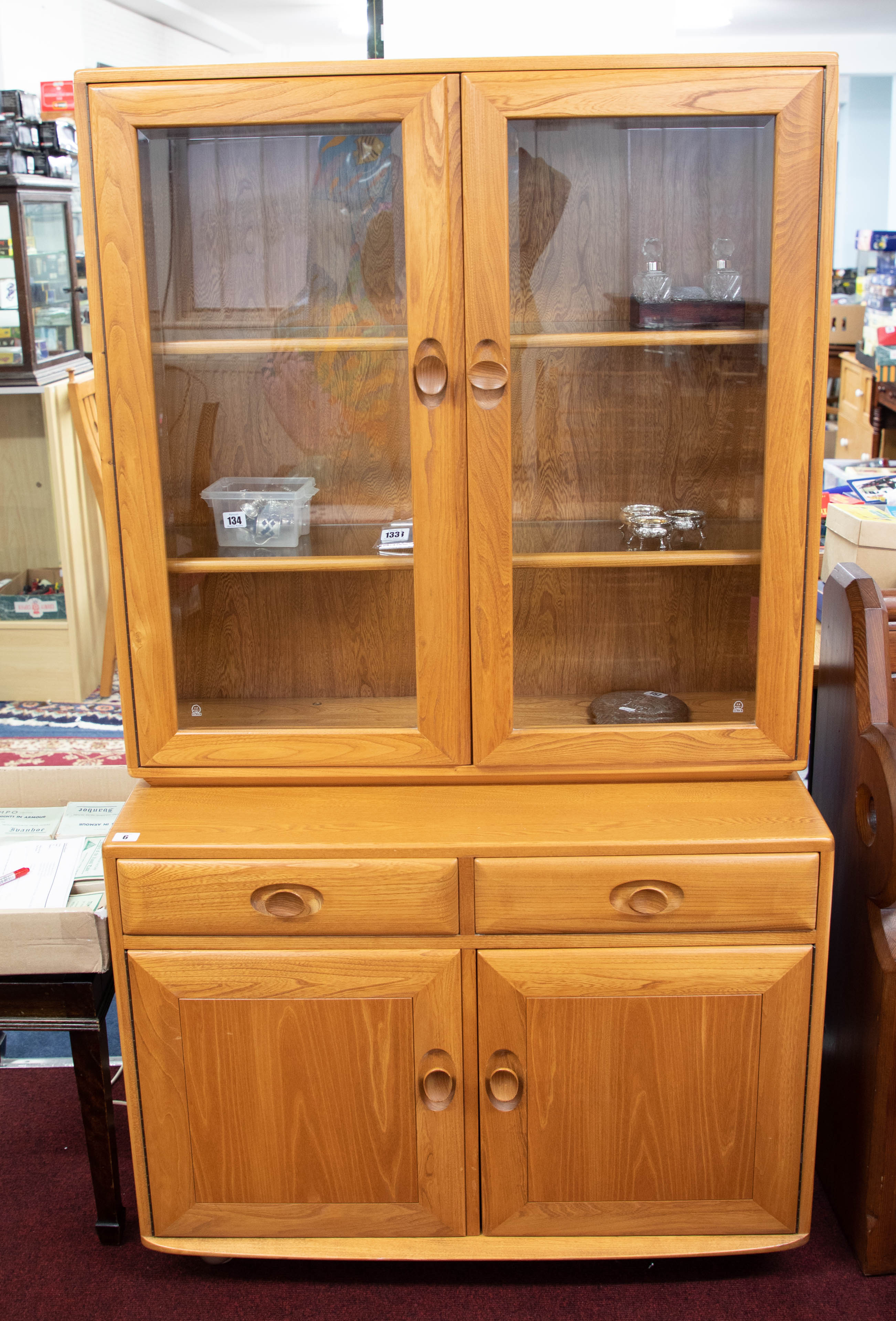 Ercol, a light wood and glazed side cabinet bookcase, width 91cm, height 162cm.