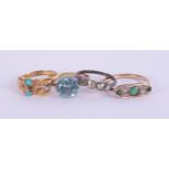 An antique turquoise set ring in yellow gold, unmarked, and three other rings including an