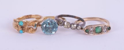 An antique turquoise set ring in yellow gold, unmarked, and three other rings including an