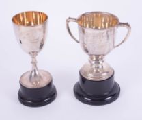 Two Geo V silver trophies including Lydford Pony Society 1928, approximately 15.45oz on socle bases.