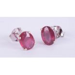 Pair of silver studs set with treated ruby.