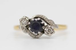 An 18ct sapphire and diamond set three stone ring, size O