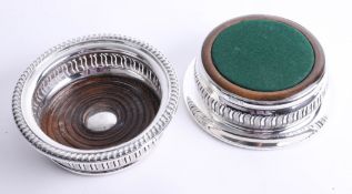 A matched pair of silver wine coasters with wood inlay, pierced and engraved surround with gadroon