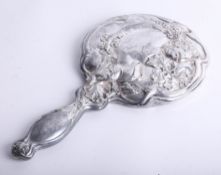 A silver hand mirror with heavy embossed flower and ribbon decoration, mirror slightly misted,