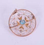 A 9ct circular pendant set with topaz? and pearl.