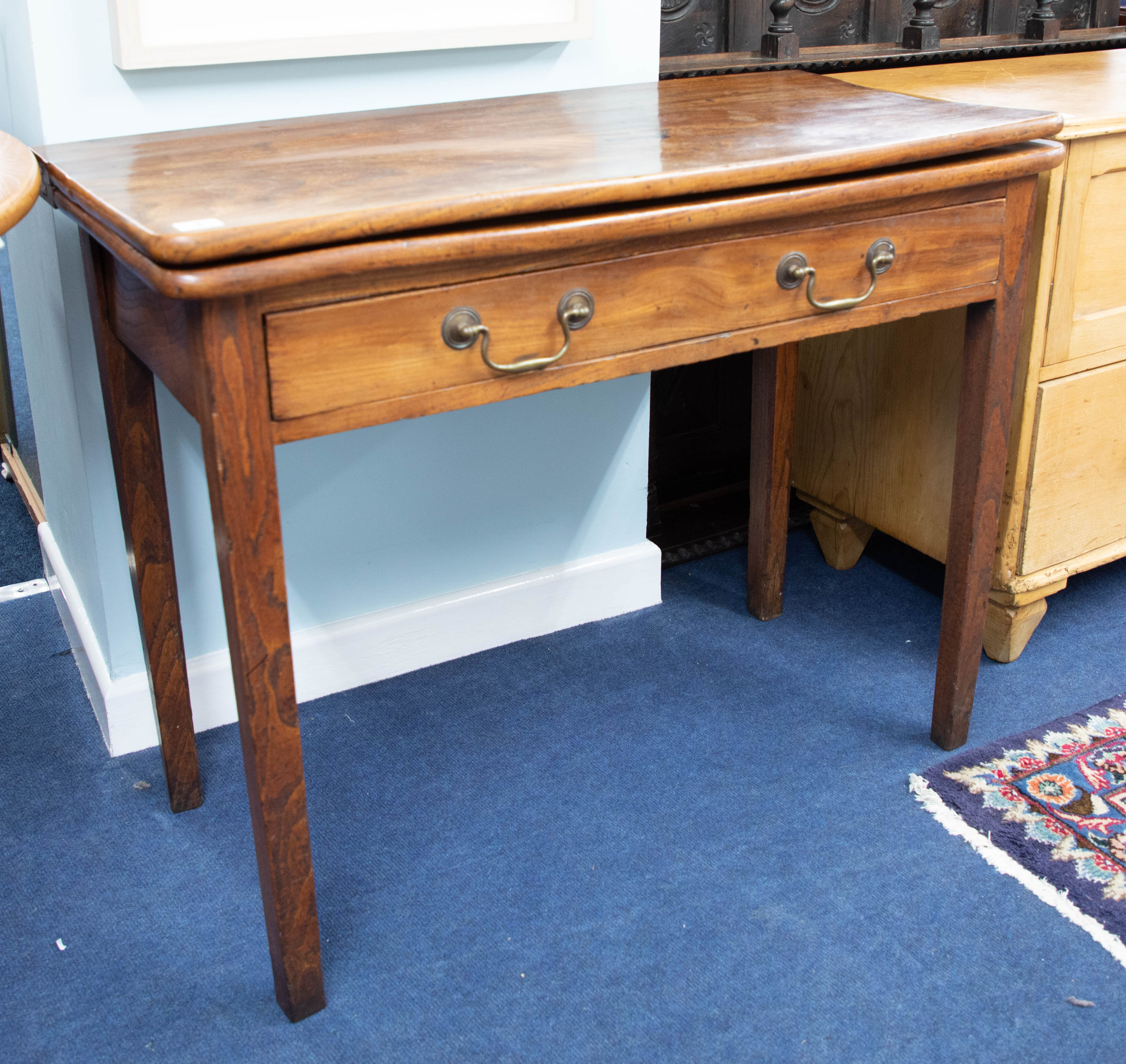 A Georgian mahogany fold over dining table fitted with a single drawer, width 90cm.