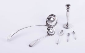 An Elkington and Co. silver-plated ladle and other plated spoons and a single candlestick.