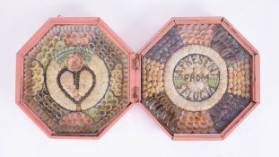 A 19th century sailor's shell Valentine in a hinged and glazed octagonal wood case, decorated 'A