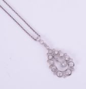 A diamond pear-shaped pendant necklace set in white metal.