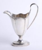 A silver cream jug with graduated fluted oval body, oval foot with rising ribbed handle, Chester