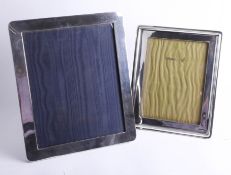 Two large silver frames, one wooden-backed, Birmingham, 8in x 6in the other by G.K. and C.K 10in x