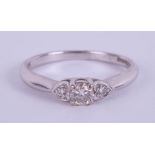 An 18ct white gold three stone diamond ring size P/Q.