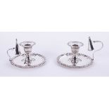 A matched pair of modern silver candlesticks, each with removable sconces and candle snuffers with
