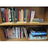 TWO SHELVES OF MILITARY RELATED BOOKS INCLUDING 'AIR RAID PRECAUTION' HANDBOOKS, AND 'A HISTORY OF