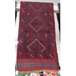 HAND KNOTTED RED GROUND PATTERNED FLOOR RUNNER WITH MULTIPLE MEDALLIONS, 244CM X 60CM