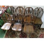 SEVEN MATCHED STAINED WOODEN WHEEL-BACK DINING CHAIRS