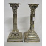 PAIR OF SILVER CLAD CANDLESTICKS, CORINTHIAN COLUMS WITH DETACHABLE NOZZLES, ON SQUARE BASES.