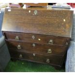 19TH CENTURY STAINED OAK BUREAU WITH THREE DRAWERS AND ORNATE BRASS HANDLES