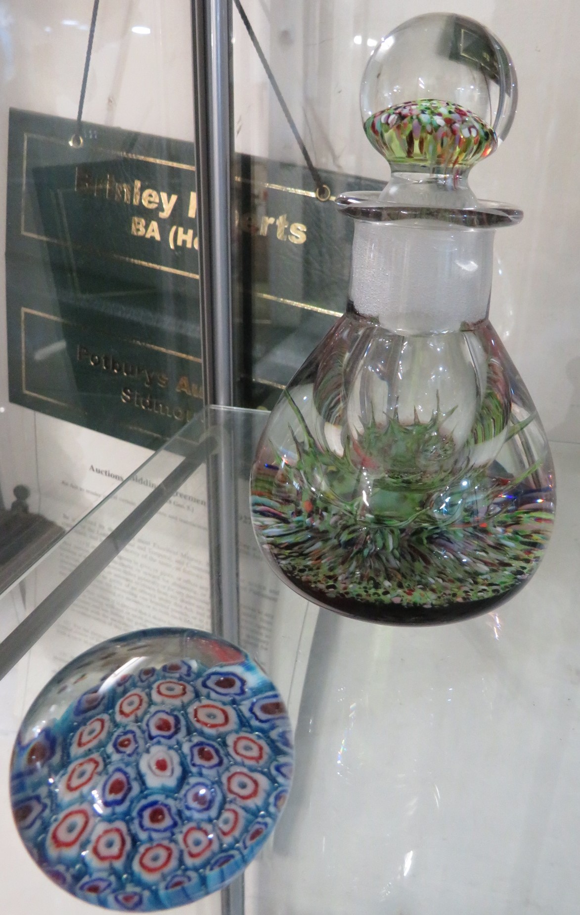 A DECORATIVE GLASS STOPPERED BOTTLE, AND A SMALL GLASS PAPERWEIGHT