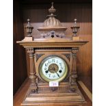 WOODEN CASED CHIMING MANTLE CLOCK WITH FINIALS