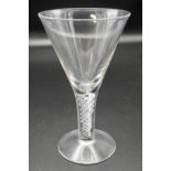 A large 19th century wine glass with conical bowl, the stem with four-strand spiral air twist,