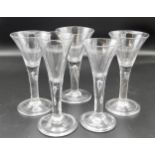 Five various early 19th century wine glasses with drawn conical bowls, the stems with single tear