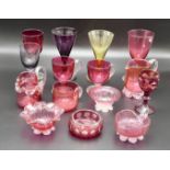 Nine items of Victorian and other cranberry glass including jugs, custards, posies, together with