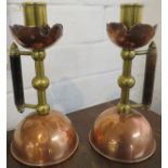Matched pair of Christopher Dresser designed candlesticks, copper and brass with domed bases and