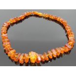 Amber necklace, irregular faceted pieces of graduated size (about 25mm to 7mm), length about 49cm,