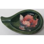 Moorcroft pottery tear-drop shape ashtray, green ground with pink hibiscus flowers, dimensions about