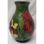 Moorcroft pottery baluster hibiscus vase, green ground with tubelined decoration of red and yellow
