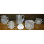 A selection of clear threaded glass - three small jugs, a vase and a three-handled beaker