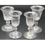 Four various 19th century wine glasses with etched vine and foliate decoration, each with baluster