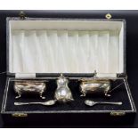 Cased silver condiment set, comprising salt and mustard with blue glass liners and raised on hoof