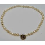 A necklace of cultured pearls, length about 37cm, with a yellow metal foliate encrusted clasp set