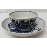 Early Caughley blue and white tea bowl and saucer, patterned with flowers and butterflies, double-