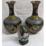 A pair of cloisonne enamel bottle vases and egg, the vases of black ground with decoration of