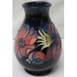 Moorcroft pottery small baluster anemone vase, dark blue ground with tubelined decoration of pink