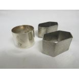 A PAIR OF LIBERTY & CO TUDRIC PEWTER HEXAGONAL NAPKIN RINGS, FULL MARKED, PATTERN NUMBER 0157; AND A