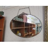 OVAL BEVELED EDGED WALL MIRROR IN A BRASS FRAME