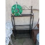 BLACK METAL THREE SHELF UNIT TOGETHER WITH A HOZELOCK REEL AND HOSE