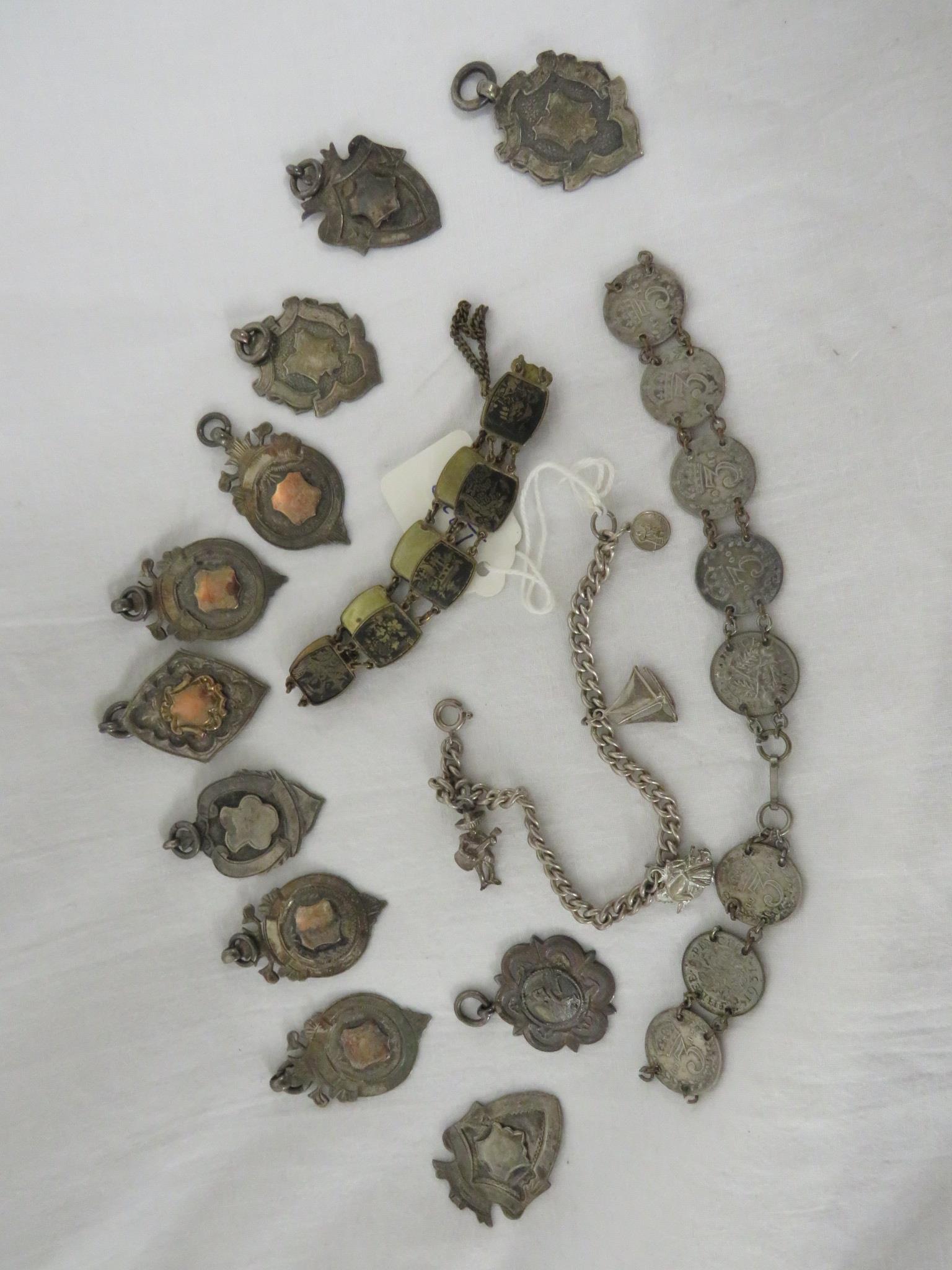 A SILVER FOOTBALL MEDALLION AND TEN OTHER SILVER MEDALLIONS, A CHARM BRACELET, SILVER THREEPENCE