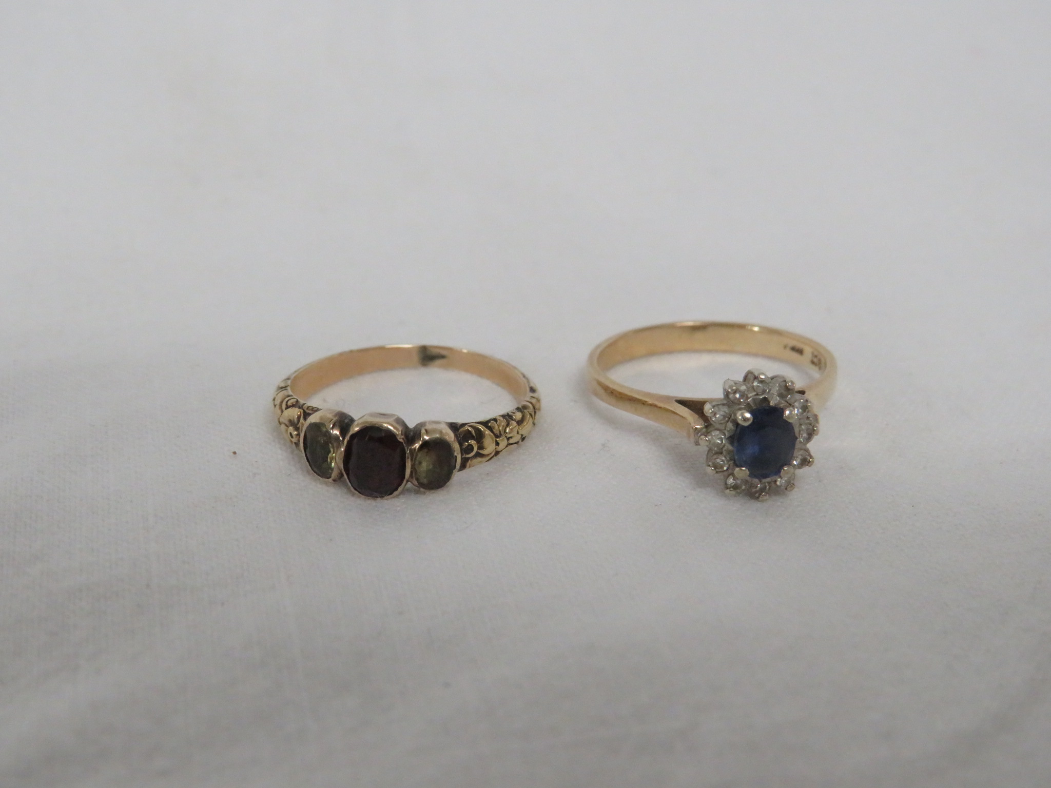 A DRESS RING SET WITH A SMALL SAPPHIRE (ABOUT 4.5MM X 3MM) SURROUNDED BY TWELVE VERY SMALL DIAMONDS, - Image 2 of 2