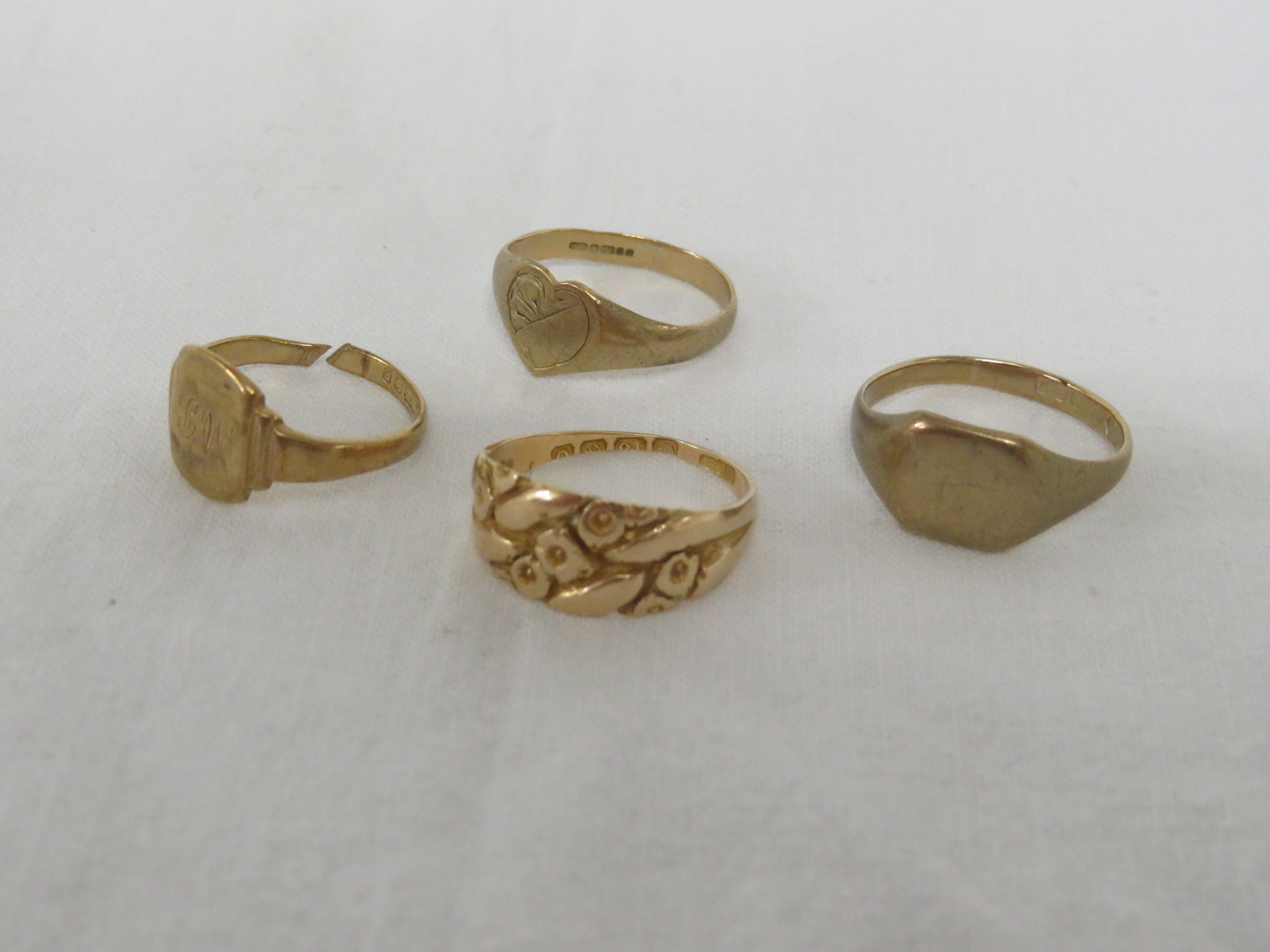 FOUR RINGS - A 9 CARAT GOLD SIGNET RING, 2.5G, SIZE O FOR GUIDANCE ONLY; A 9 CARAT GOLD RING WITH