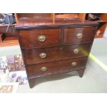 AN EARLY 19TH CENTURY BANDED MAHOGANY CHEST OF TWO SHORT OVER TWO LONG DRAWERS, BRASS HANDLES