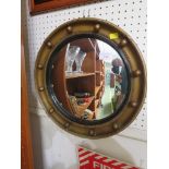 CIRCULAR CONVEX WALL MIRROR IN A GILT FRAME