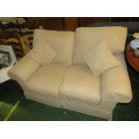 TWO-SEATER SOFA WITH BEIGE LOOSE COVERS