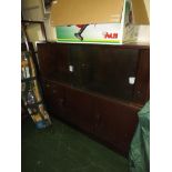 STAINED OAK THREE-DOOR CUPBOARD WITH SLIDING GLASS DOORS AND ADJUSTABLE SHELVES